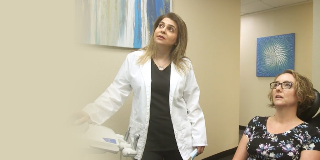 Patient and doctor looking at dental information for patients procedure