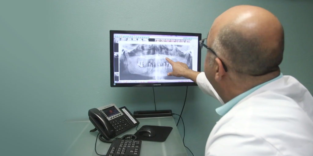 Doctor going over dental images with patient within the dental practice
