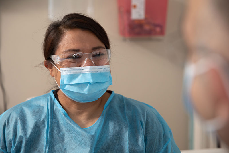 Staff member assisting with guided dental implant surgery