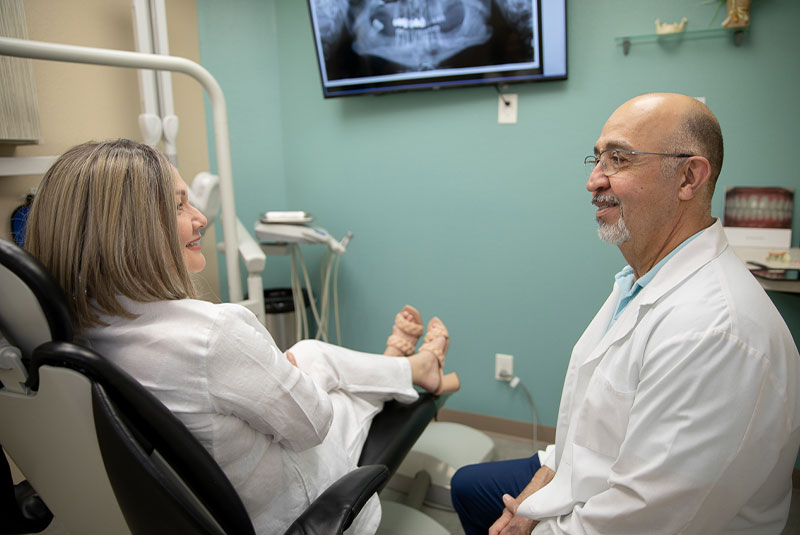 Doctor going over dental implant information with patient within the dental office