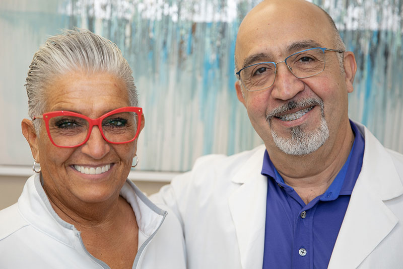 Patient and doctor smiling after patient dental procedure