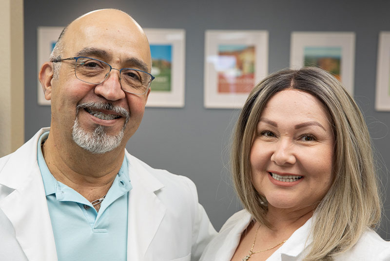 Patient and doctor smiling after patient dental procedure