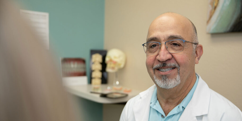 doctor going over dental information with patient within the dental office